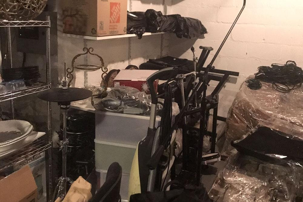 Basement storage space with exercise equipment and miscellaneous items