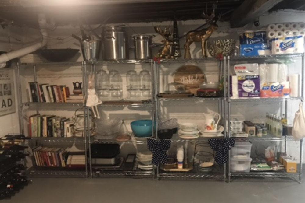 Organized basement shelving with books, kitchenware, and household items