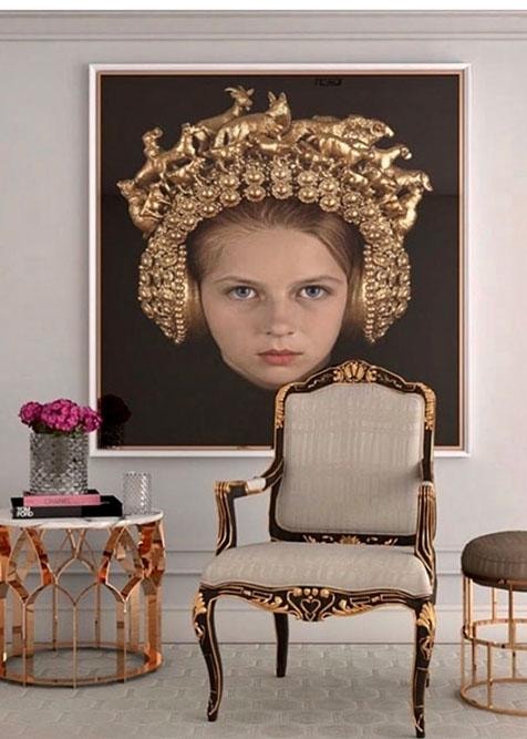Luxury sitting room with ornate gold chair and large portrait artwork